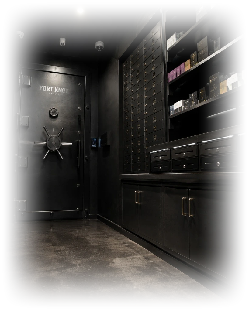 A heavy vault door labeled Fort Knox Vaults beside a wall of secured storage drawers and shelving